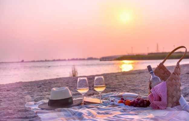 Picnic with wine on the beach by the sea Romantic Getaways rock adventures body