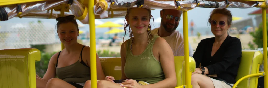 happy travellers on yellow tuk tuk rock adventures antigua